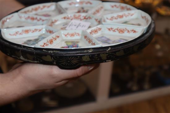 A 19th century Chinese famille rose immortals supper dish set, lacquer base only.